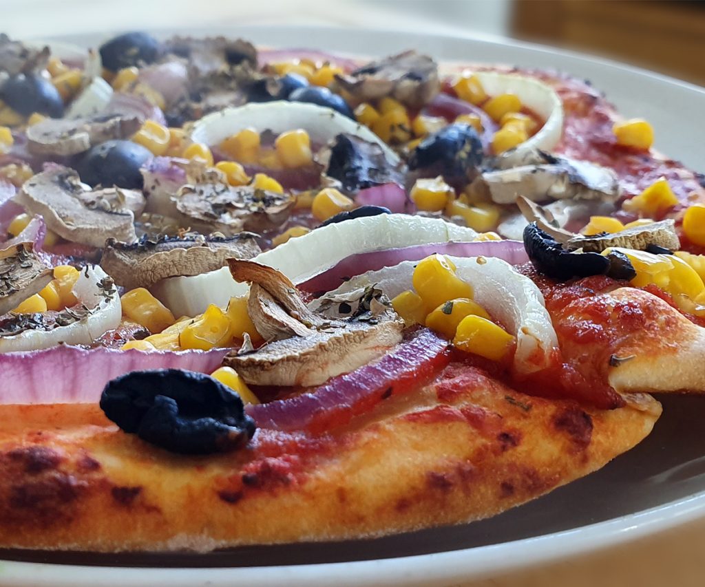 Pizza with onions, mushroom, olives and sweetcorn