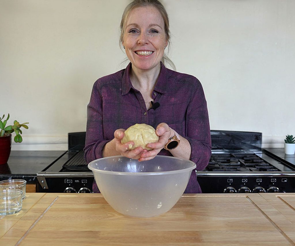 A woman holding sweet pastry