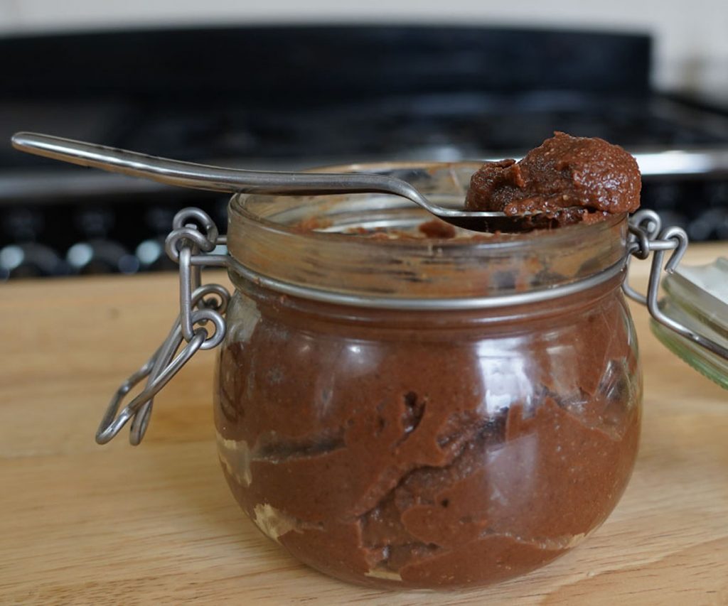 A jar of raw hazelnut chocolate spread.